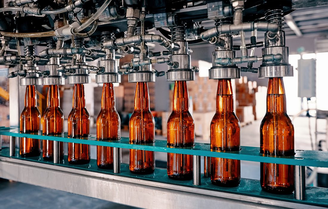 Beer bottles on automated filling line.