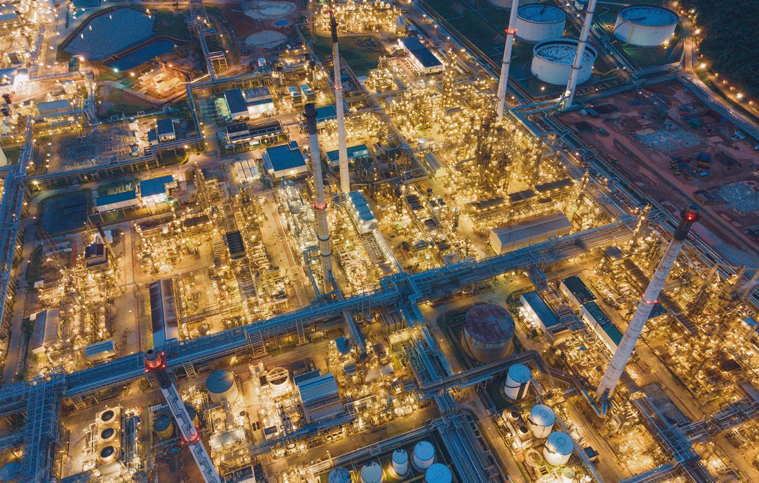 Aerial view of illuminated industrial complex.