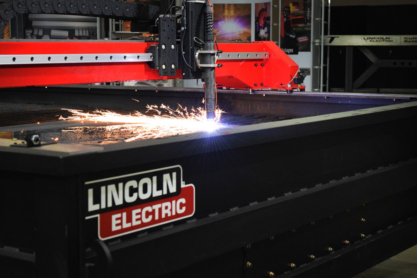 Plasma cutter with sparks on metal table.