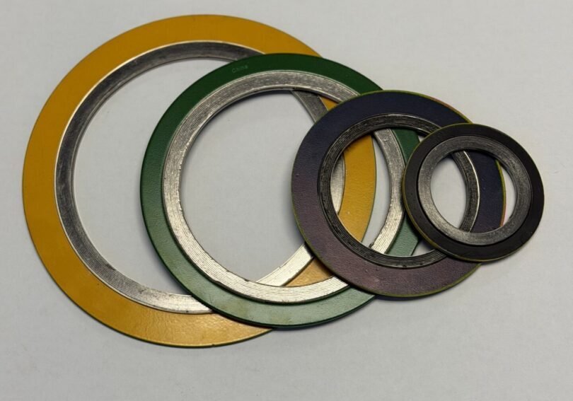 stacked colored metal washers on white background